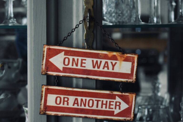 Vintage directional signs pointing left and right with the words “one way” and “or another,” symbolizing the importance of making better choices.