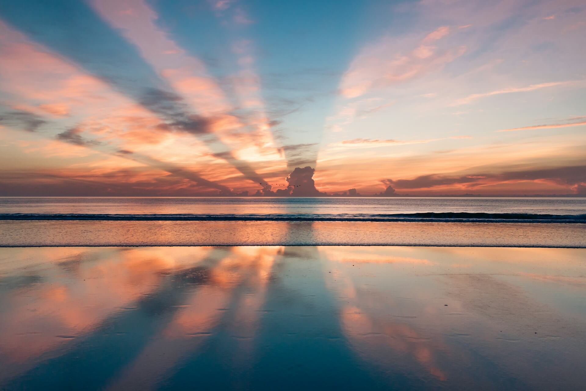 Peaceful ocean sunset with soft clouds and colorful reflections on the water, symbolizing calmness and the process of learning to control anger.